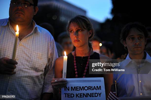 From left, Joaquin Guerra, Julia Eisman, and Brian Komar, attend a candlelight vigil in Dupont Circle organized by MoveOn in honor of the late Sen....