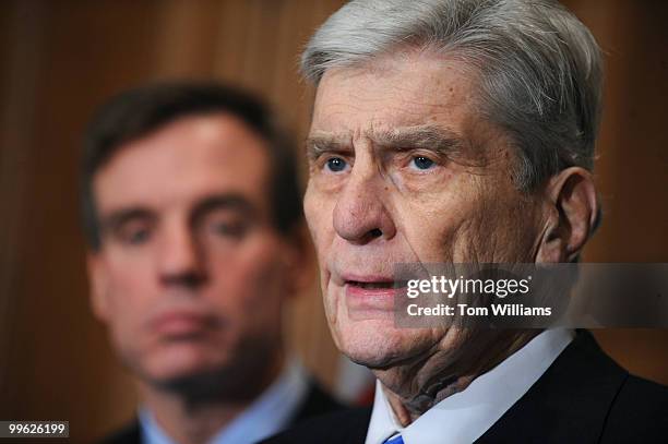 Sen.-elect Mark Warner, D-Va., left, listens to Sen. John Warner, R-Va., speak at a news conference on the Navy's announcement to create a second...