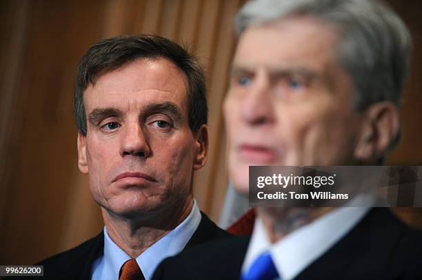 Sen.-elect Mark Warner, D-Va., left, listens to Sen. John Warner, R-Va., speak at a news conference on the Navy's announcement to create a second...