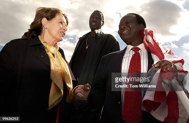 Simon Deng, a former slave from Sudan, talks with House Minority Leader Nancy Pelosi, D-Calif., at a rally which concluded his 300 mile Sudan Freedom...
