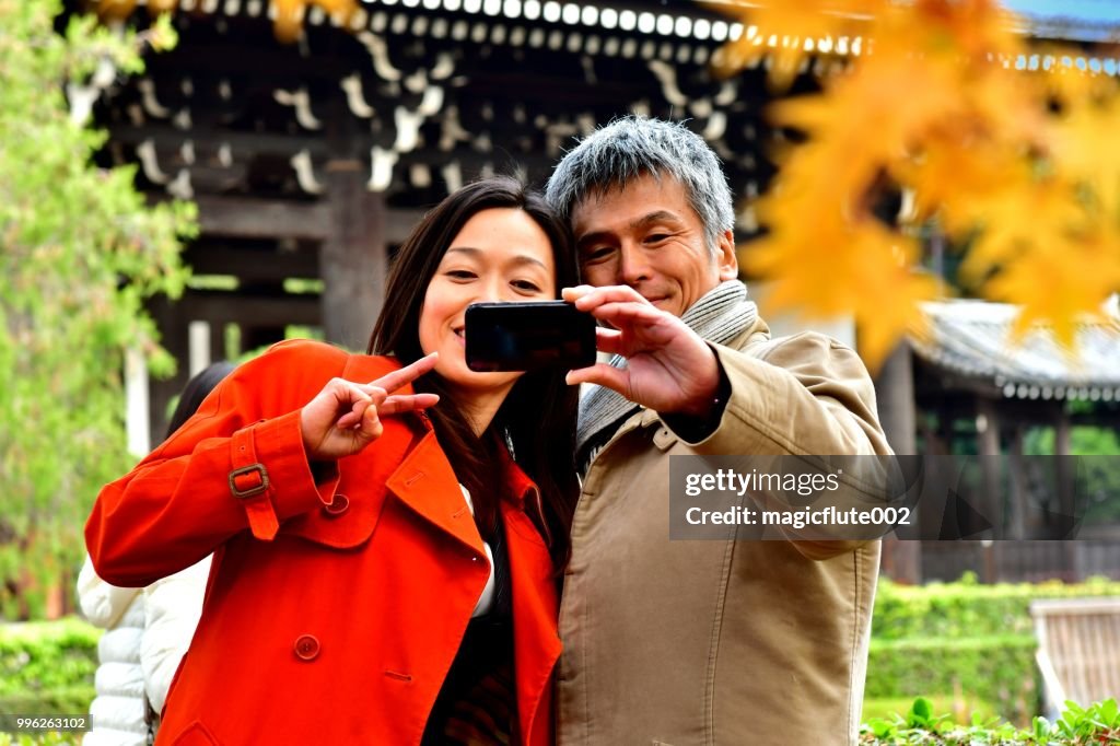 Japanese Couple in their 40's Taking Selfie at Tofuku-ji Temple, Kyoto