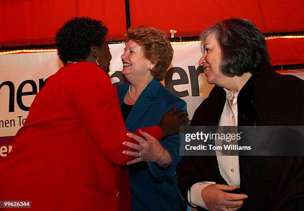 Sen. Debbie Stabenow, D-Mich., center, hugs, Rep. Stephanie Tubbs Jones, D-Ohio., as Susan Turnbull, DNC vice chair, looks on, before a event hosted...