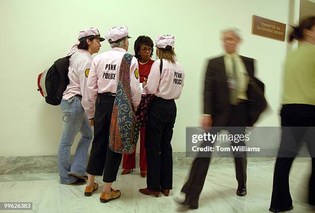 Rep. Maxine Waters, D-Calif., talks with Code Pink members outside a House Government Reform Committee meeting to consider issuing subpoenas for...