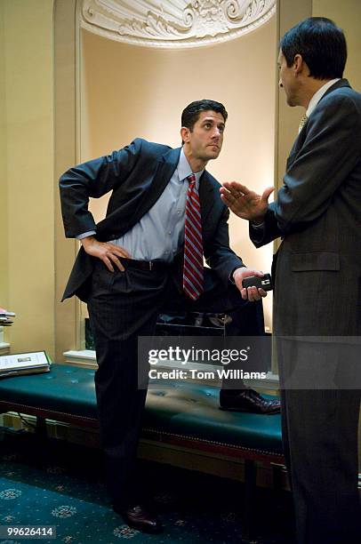 Rep. Paul Ryan, R-Wisc., talks with a colleague before a House Ways and Means Committee markup on the approval of the reconciliation letter to the...