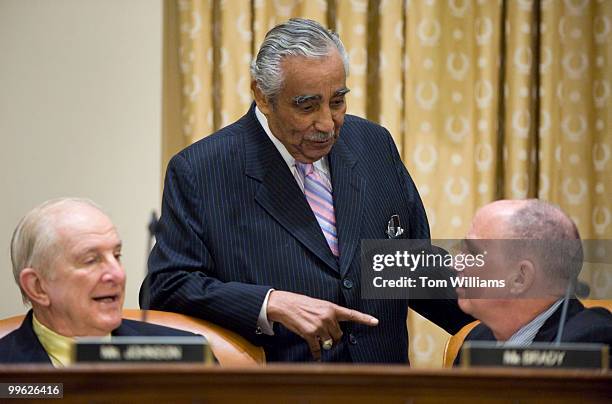 Chairman Charlie Rangel, D-N.Y., center, confers with Reps. Sam Johnson, R-Texas, and Kevin Brady, R-Texas, before a House Ways and Means Committee...