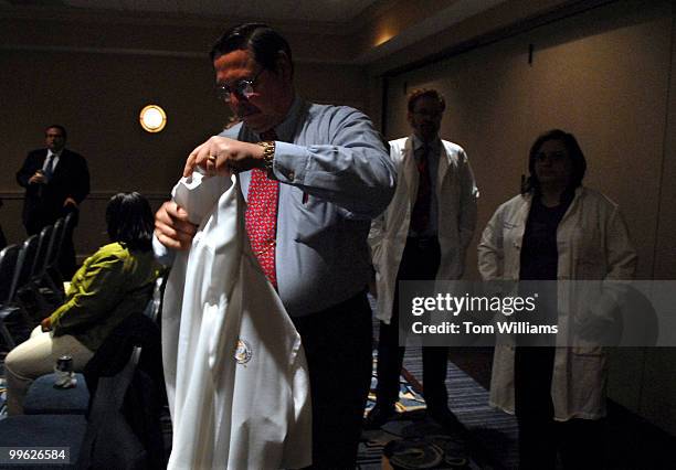 Bob Macomber, a physician's assistant from the New York State Department of Correctional Services puts on a garb for the 3rd Annual White Coat Days....