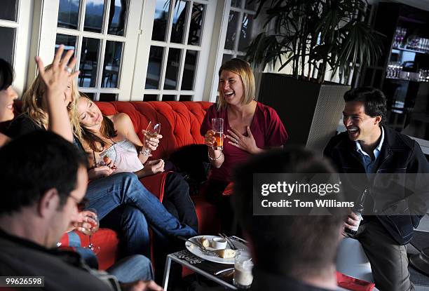 Leslie Ryan, center, and Pete Ryan, share a laugh with friends at the POV Terrace on the roof of the W Hotel, Oct. 12, 2009.