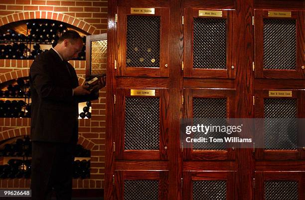 Daniel Festa of Morton's SteakHouse, on Conn. Ave., pulls wine out a wine locker that the have in the establishment.