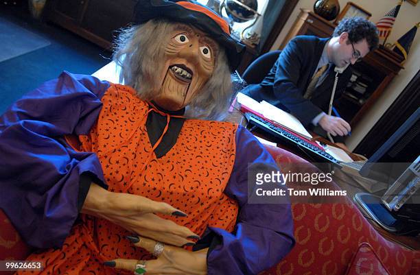 Life sized witch sits on a couch in the office of Sen. Chuck Hagel, R-Neb., as Eric Schewe works the phones.
