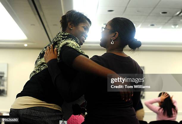 Stephanie Gidigbi, left, from the office of Rep. Donald Payne, D-N.J., greets Tamika Day, from the office of Majority Whip James Clyburn, D-S.C.,...