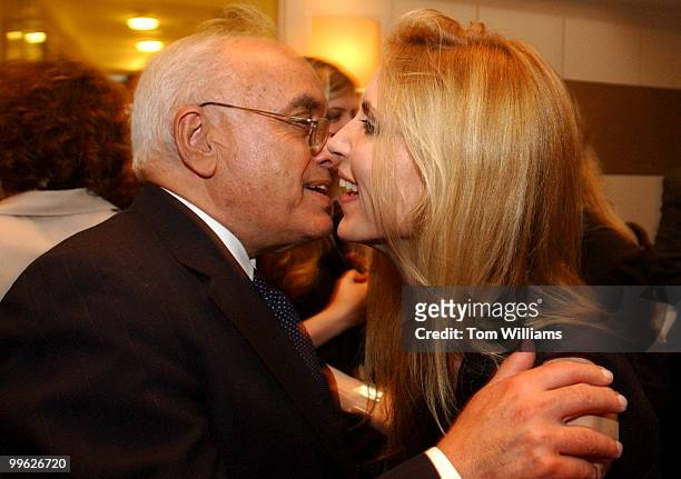 Writers Bob Novak and Ann Coulter embrace at a party in the George Hotel on Capitol Hil.