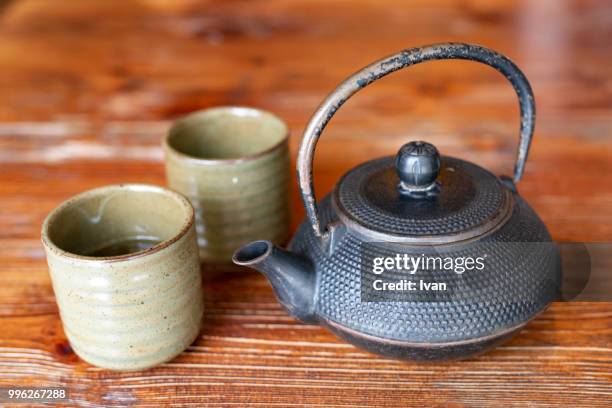 traditional japanese cast iron teapot (chagama), meringues, grey (tetsubin) kettle and tea cups - japanese tea cup stock pictures, royalty-free photos & images