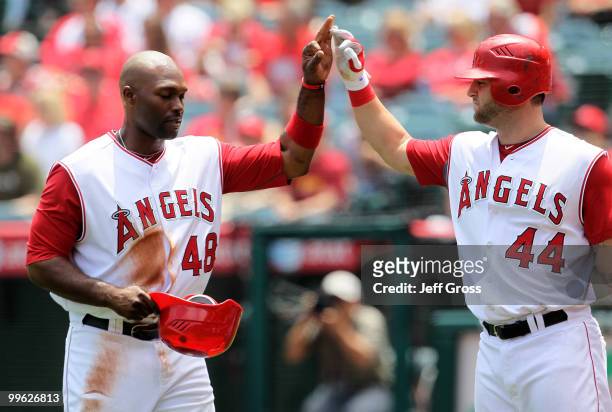 Torii Hunter the Los Angeles Angels of Anaheim is congratulated by Mike Napoli after scoring on a base hit by Hideki Matsui in the second inning...