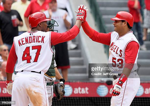 Bobby Abreu the Los Angeles Angels of Anaheim is congratulated by Howie Kendrick after hitting a two-run homerun in the sixth inning against the...