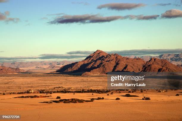 view from elim dune onto grass steppe, sesriem camp and tsaris mountains, namib desert, namib naukluft park, namibia - skeleton coast national park stock pictures, royalty-free photos & images