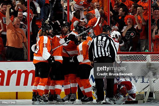 Braydon Coburn of the Philadelphia Flyers celebrates after his goal with teammates Danny Briere, Scott Hartnell and Kimmo Timonen in the first period...