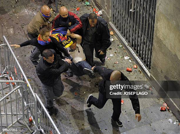 Undercover agents take action after unrest broke out during Barcelona's celebration for their victory in their Spanish League football match against...