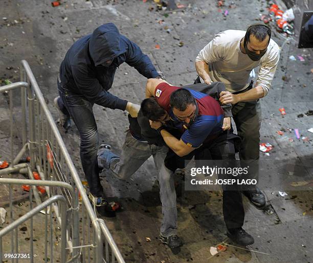 Undercover agents take action after unrest broke out during Barcelona's celebration for their victory in their Spanish League football match against...