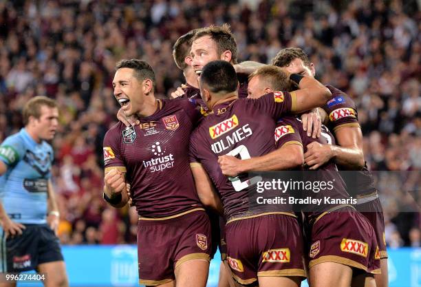 Daly Cherry-Evans of Queensland is congratulated by Billy Slater and team mates after scoring a try during game three of the State of Origin series...