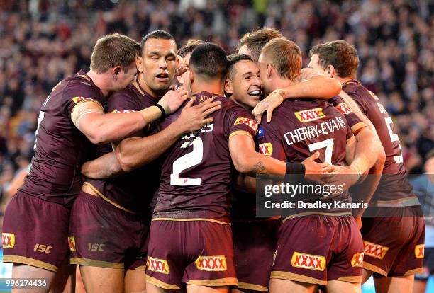 Daly Cherry-Evans of Queensland is congratulated by Billy Slater and team mates after scoring a try during game three of the State of Origin series...