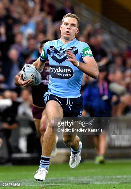 Tom Trbojevic of the Blues breaks away from the defence during game three of the State of Origin series between the Queensland Maroons and the New...