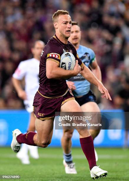 Daly Cherry-Evans of Queensland breaks away from the defence during game three of the State of Origin series between the Queensland Maroons and the...