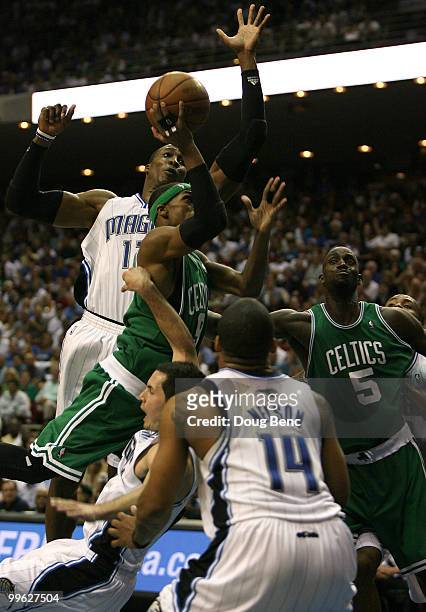 Rajon Rondo of the Boston Celtics drives for a shot attempt against J.J. Redick, Dwight Howard and Jameer Nelson of the Orlando Magic in Game One of...