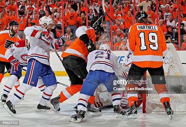 Scott Hartnell of the Philadelphia Flyers watches as teammate Braydon Coburn scores a goal against Brian Gionta and goaltender Jaroslav Halak of the...