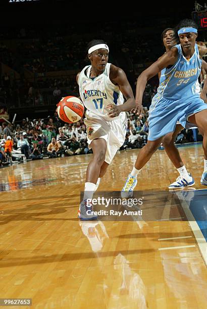 Essence Carson of the New York Liberty drives against Sylvia Fowles of the Chicago Sky during the game on May 16, 2010 at Madison Square Garden in...