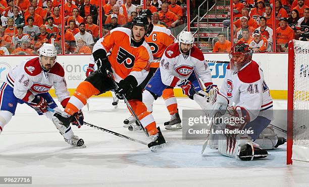 Tomas Plekanec, Roman Hamrlik and goaltender Jaroslav Halak of the Montreal Canadiens defend against the attack of Dan Carcillo of the Philadelphia...