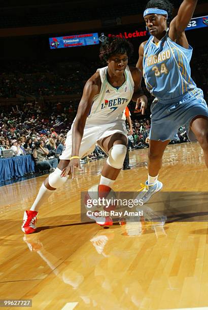 Taj McWilliams-Franklin of the New York Liberty drives against Sylvia Fowles of the Chicago Sky during the game on May 16, 2010 at Madison Square...