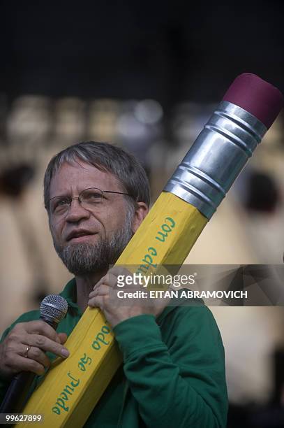 Colombian presidential candidate for the Green Party, Antanas Mockus, holds a giant pencil reading " With education we can" during a rally in Bogota...
