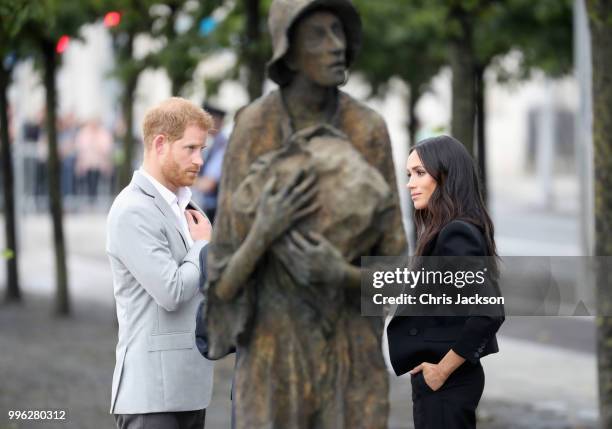 Prince Harry, Duke of Sussex and Meghan, Duchess of Sussex view the Famine Memorial on the bank of the River Liffey during their visit to Ireland on...