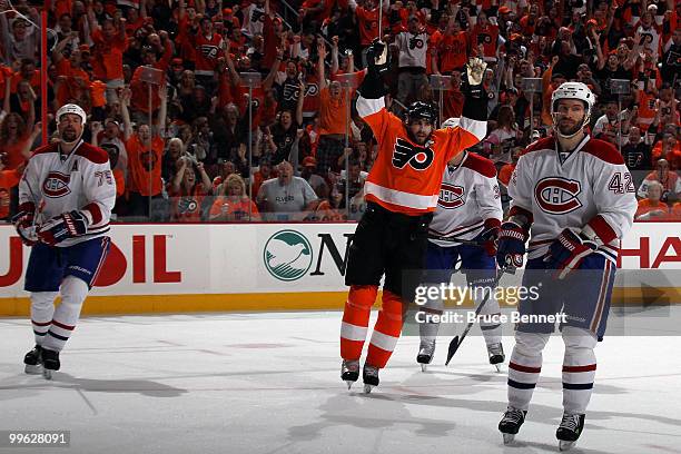 Simon Gagne of the Philadelphia Flyers celebates after scoring a goal in the second period as Dominic Moore and Hal Gill of the Montreal Canadiens...