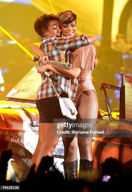 Rihanna invites a fan onstage while performing at MEN Arena on May 16, 2010 in Manchester, England.