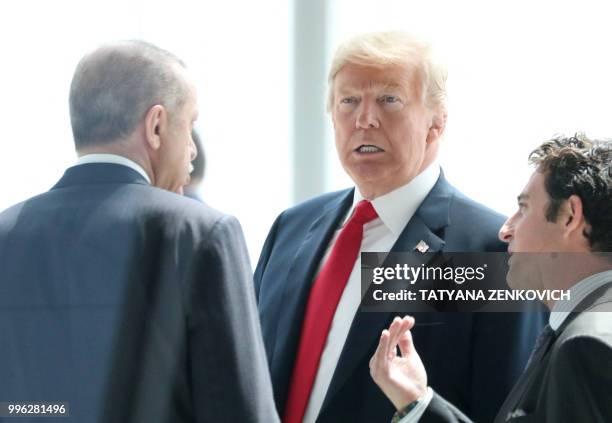 President Donald Trump talks with Turkey's President Recep Tayyip Erdogan as they arrive for the NATO summit, at the NATO headquarters in Brussels,...