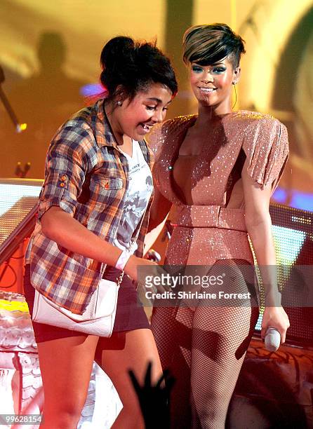 Rihanna invites a fan onstage while performing at MEN Arena on May 16, 2010 in Manchester, England.