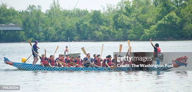 The Ninth Annual Dragon Boat Races were held on May 15 and 16th in Washington, DC at Thompson Boat Center. One of the boats celebrate as they cross...