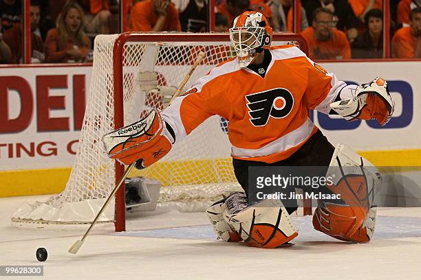 Michael Leighton of the Philadelphia Flyers clears the puck against the Montreal Canadiens in Game 1 of the Eastern Conference Finals during the 2010...