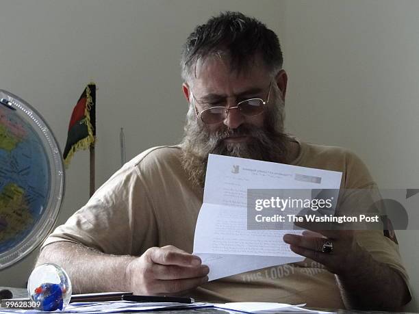 Afghan Border Police Col. Shamsu Rahman reviews a letter written by Lt. Col. Robert B. Brown to Mullah Sadiq, an insurgent leader, in September 2009....