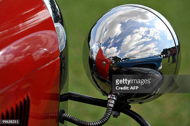 Chevrolet Pick Up is reflected in the lantern of a classic car during the XXII National Meeting of Antique and Classic Car Clubs in Palmira, Valle...