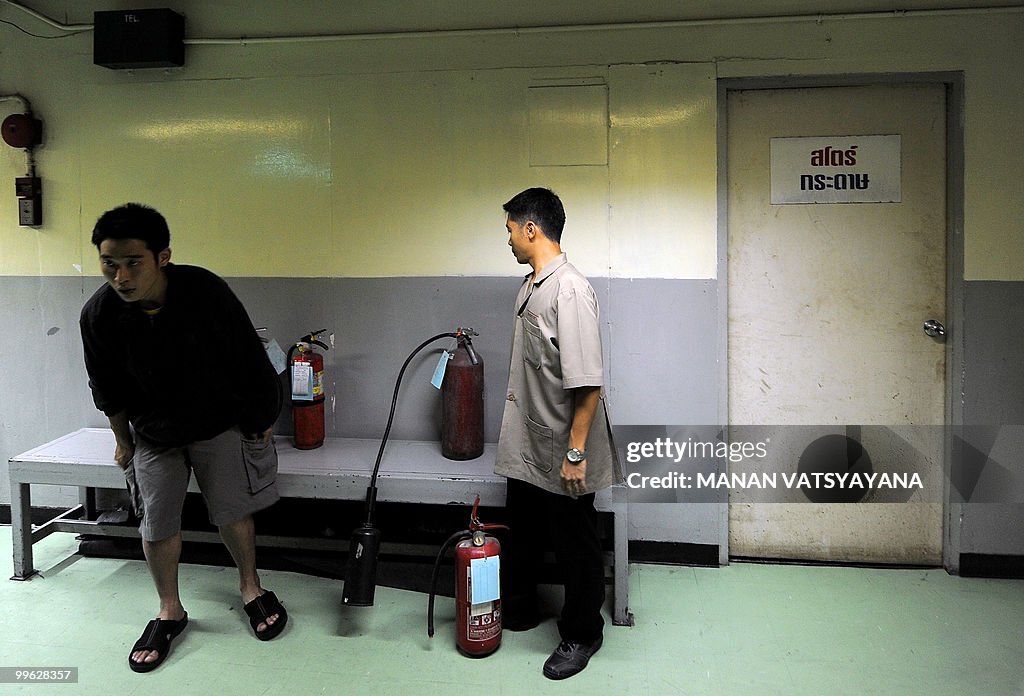 Hotel staff arrange fire extinguishers i