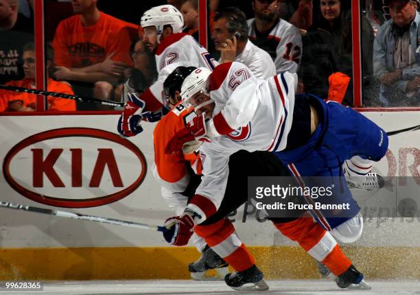 Benoit Pouliot of the Montreal Canadiens gets knocked off his skates against Danny Briere of the Philadelphia Flyers in Game 1 of the Eastern...