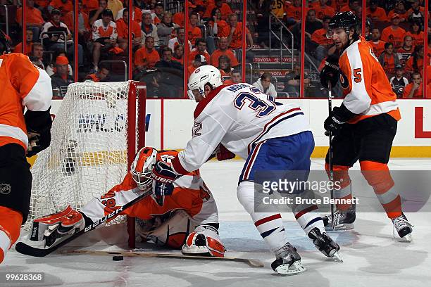 Goalie Michael Leighton of the Philadelphia Flyers makes a save against Travis Moen of the Montreal Canadiens in Game 1 of the Eastern Conference...