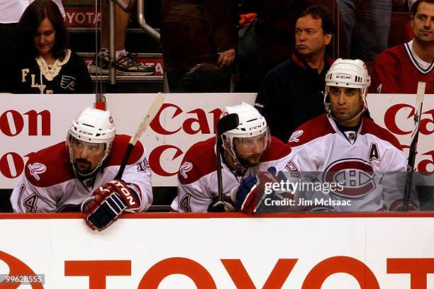 Tomas Plekanec, Tom Pyatt and Scott Gomez of the Montreal Canadiens sit on the bench while playing against the Philadelphia Flyers in Game 1 of the...