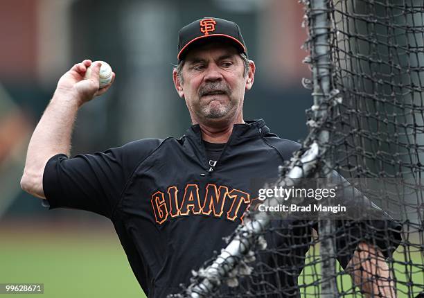 Manager Bruce Bochy of the San Francisco Giants pitches batting practice before the game against the Houston Astros at AT&T Park on May 16, 2010 in...