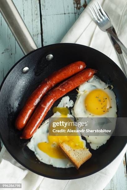 fried eggs with sausages - sherstobitov stock pictures, royalty-free photos & images