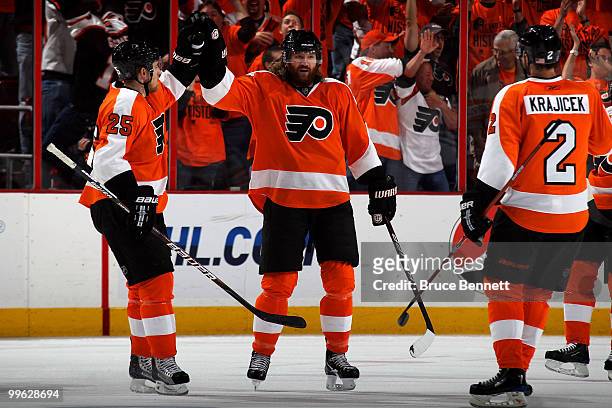 Scott Hartnell of the Philadelphia Flyers celebates with Matt Carle and Lukas Krajicek after scoring a goal in the third period against the Montreal...
