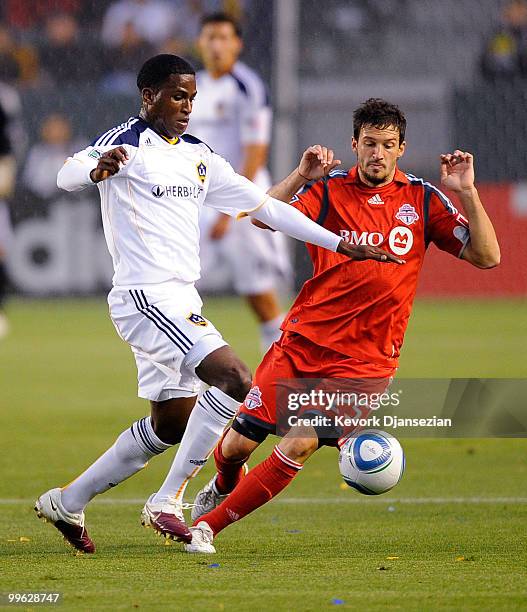 Edson Buddle of Los Angeles Galaxy controls the ball against Martin Saric of Toronto FC during the first half of the MLS soccer match on May 15, 2010...