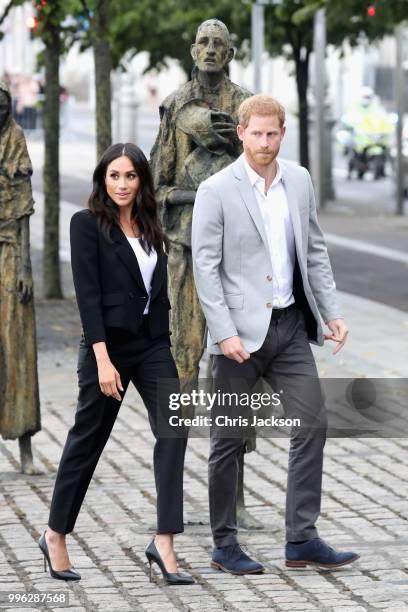 Prince Harry, Duke of Sussex and Meghan, Duchess of Sussex view the Famine Memorial on the bank of the River Liffey during their visit to Ireland on...